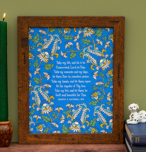 Take My Life, and Let It Be hymn art print features text of the cherished hymn surrounded by striking botanical illustrations in yellow and blue against a blueberry background; shown in a frame styled with a candle, a book, and an animal figurine