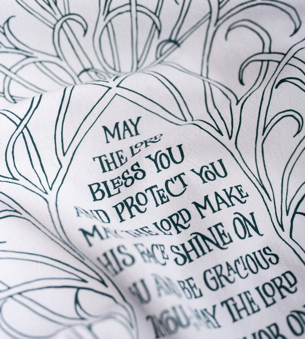 Text and illustration detail of the The Blessing Scripture tea towel is printed in muted blue-green tone and features the verse from Numbers 6:24–26.