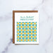 The Congratulations greeting card features a hand illustrated patterned floral highlighted with blues and yellows on a cream background with a blank inside, shown with a kraft paper envelope against a white marble backdrop.