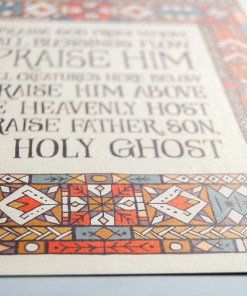 Hand lettered text detail of Doxology wall art — Christian picture for wall featuring hand lettered text surrounded by a multi-coloured stained glass illustration