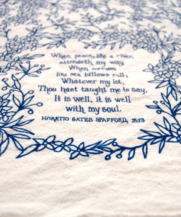 Text and floral detail of It Is Well With My Soul tea towel is printed in a striking cobalt blue.