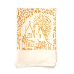 This fall tea towel, or autumn tea towel, is printed in fresh pumpkin orange, displayed folded to feature the illustrated English Tudor-style home