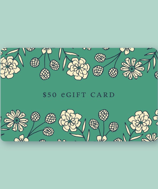 A Little Things Studio gift card in the amount of $50—a sage green card featuring custom LTS floral illustrations, shown against a light green background.