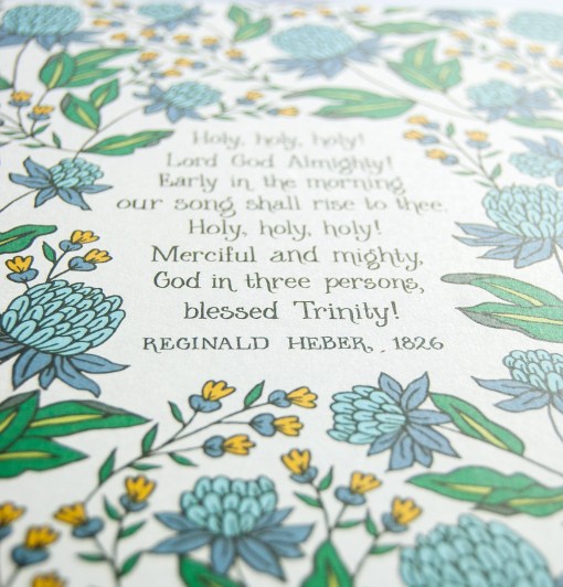 Floral illustration detail of the Holy Holy Holy art print — biblical wall art featuring hand lettered text surrounded by floral illustrations in shades of blue, yellow, and green.