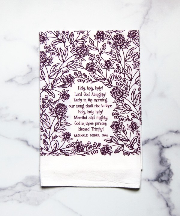 Holy Holy Holy hymn towel printed in royal purple, folded and displayed with a white marble background