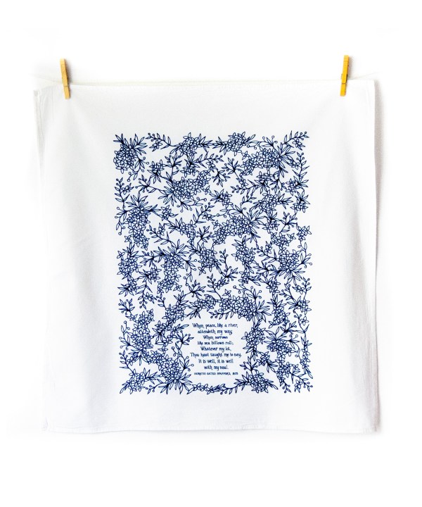 It Is Well With My Soul tea towel is printed in a striking cobalt blue and is shown unfolded and hanging with clothes pins.