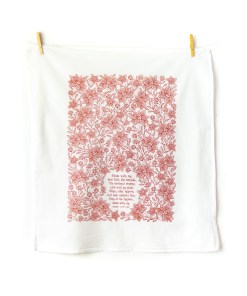 Abide with Me hymn tea towel printed in apple red, pictured unfolded, hanging with clothes pins