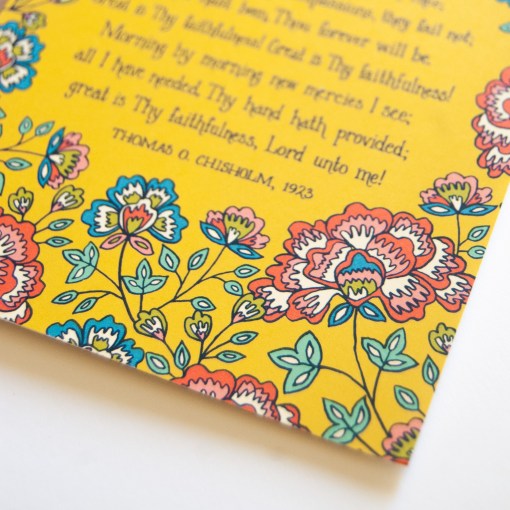 Floral and text detail of the Great is Thy Faithfulness greeting card, which features vibrantly colored floral design against a striking yellow background; displayed against a white background.