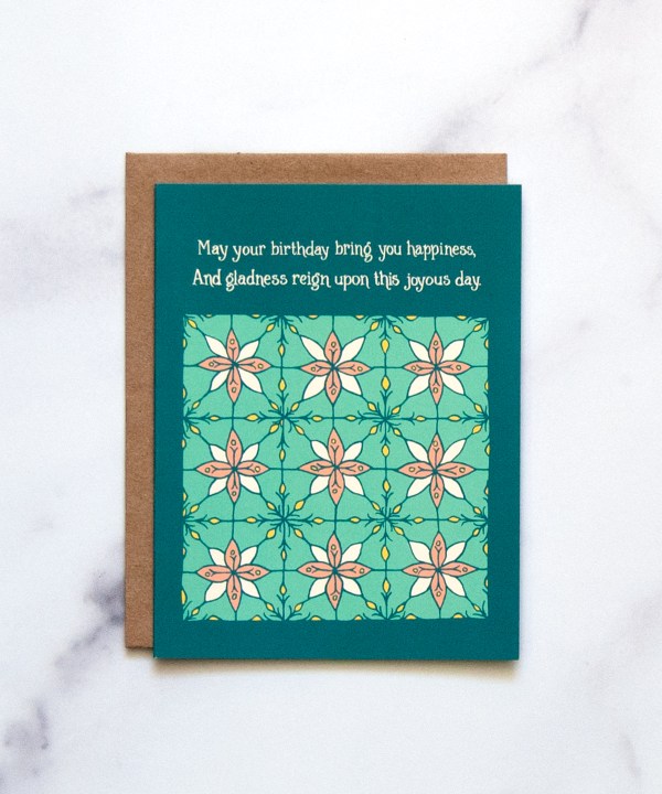 The Birthday Happiness Greeting Card features hand illustrated floral patterns in blue-greens and a splash of pink—a blank birthday card ready for your message