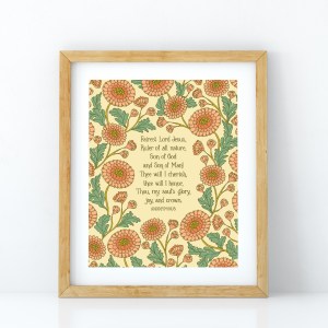 Fairest Lord Jesus wall art — a Christian art print showcasing hand-lettered hymn text surrounded by floral design in shades of pink, light orange and green, displayed in a light wood frame