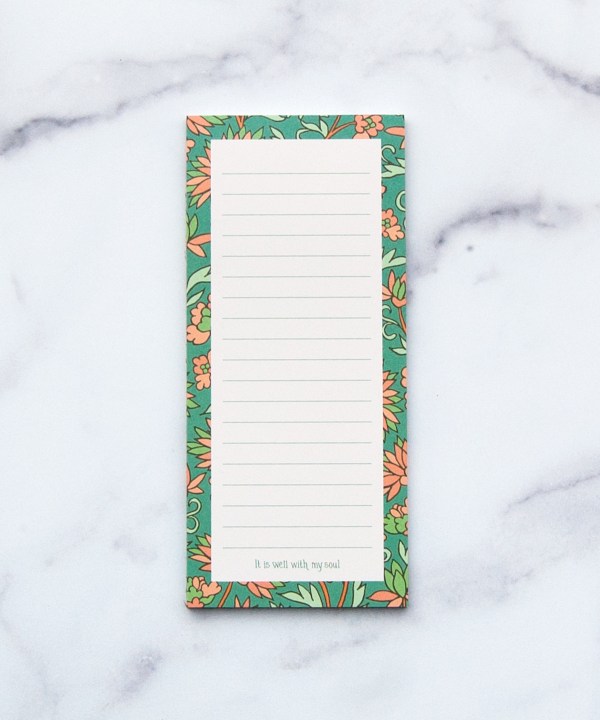 "It is Well" Notepad with a hand illustrated floral border; each page also carries the message of "It is well, with my soul" at the bottom and a magnetic back.