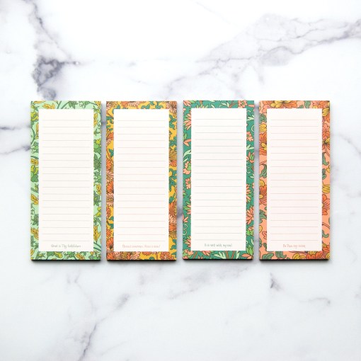 This hymn notepad set of 4 features hand illustrated borders, a line from a beloved hymn at the bottom, and a magnet on back, shown here against a white marble background.