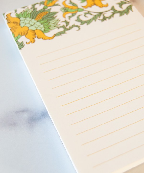 small gold floral illustrated notepad with lines