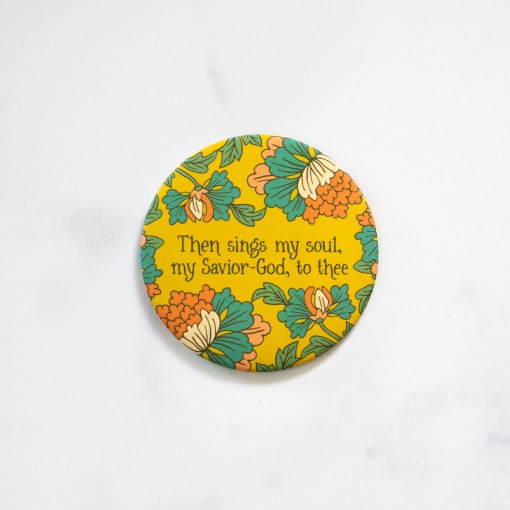 How great thou art hymn magnet with colorful floral on mustard background, displayed against a marble backdrop