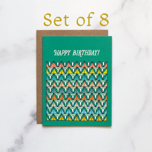 The Happy Birthday! card is a blank birthday card with cheerful, vibrant illustrations against a happy green background, shown here against a white marble backdrop.