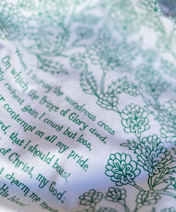 Text detail of the When I Survey the Wondrous Cross hymn tea towel, which features the beloved hymn printed in a brilliant emerald green.