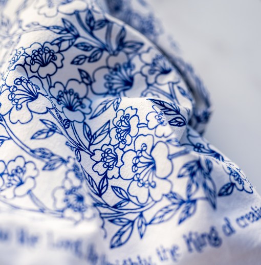 Detail image of "Praise to the Lord" hymn cloth napkins use the same flour sack cotton as our tea towels. These are printed in blueberry with a beautiful floral illustration and the hymn text printed around the edge.