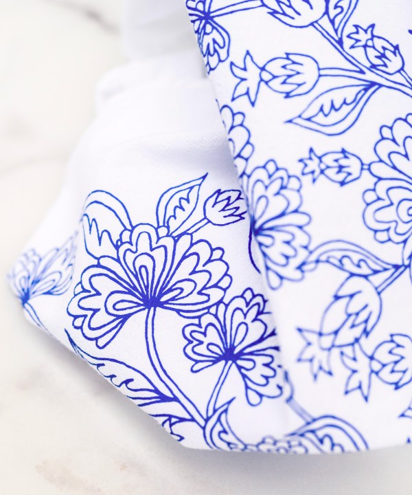 Little Things Studio presents floral tea towels featuring our unique illustrations in colorful hues. The Francine floral tea towel displays airy floral design of flowers and buds in a bright bluebell, displayed up close in detail against a marble backdrop.
