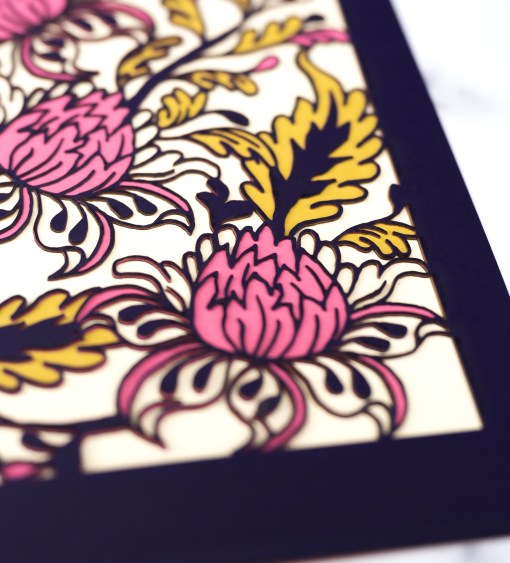 Detail image of the Layered Floral Papercut “Lyra” (Violet) which is made using cardstock in hues of violet, deep pretty pink, mustard, and cream.