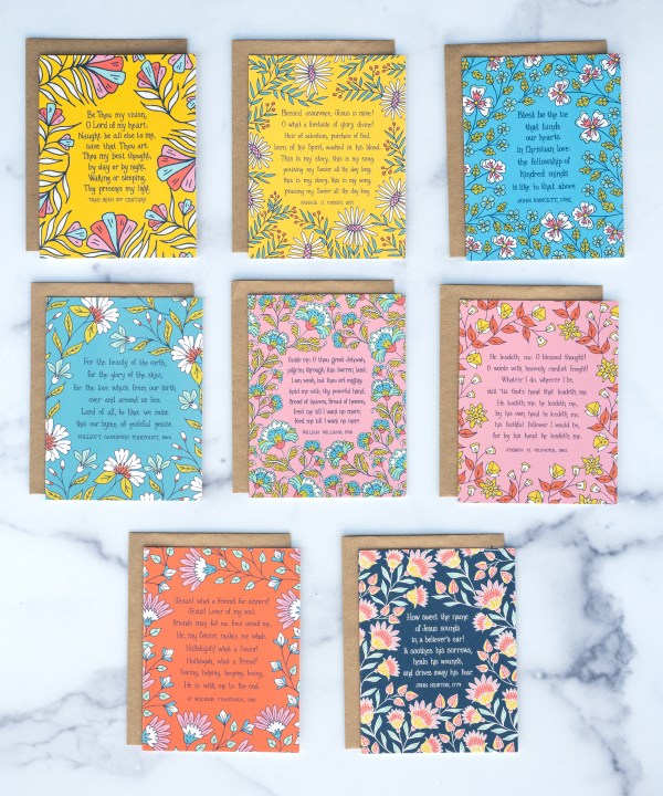 These 8 hymn greeting cards are the perfect way to say "I'm thinking of you" or "I care about you." Each card features a hymn's lyrics on the front and its history on the back. Shown as the set of 8 with kraft paper envelopes against a marble background.