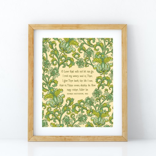 The "O Love That Wilt Not Let Me Go" hymn art print features a hand-lettered verse of the well-loved hymn surrounded by striking green floral illustrations, shown in a wooden frame against a white background.
